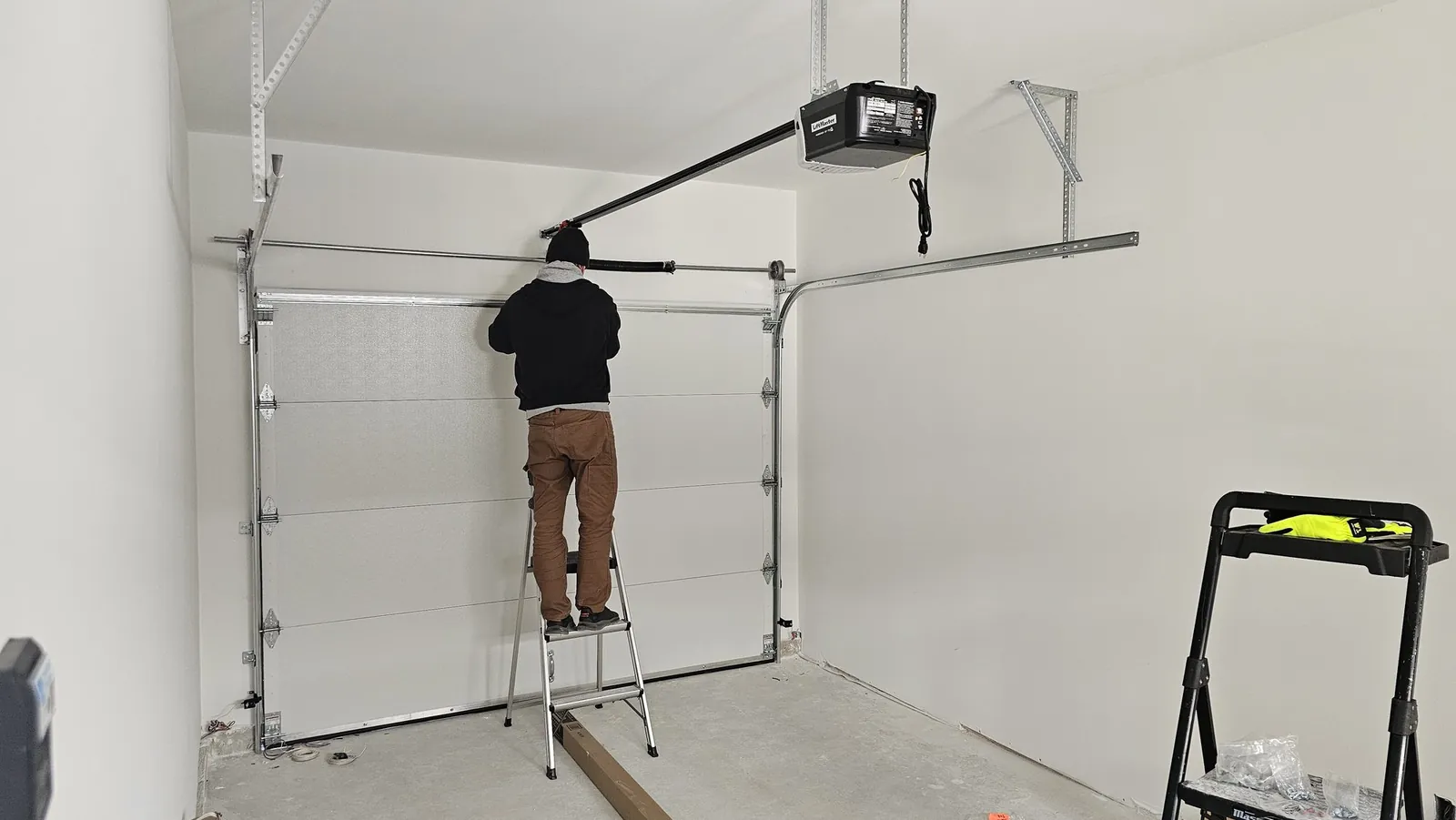 Technician installing a new garage door in an English Bluff, Tsawwassen garage