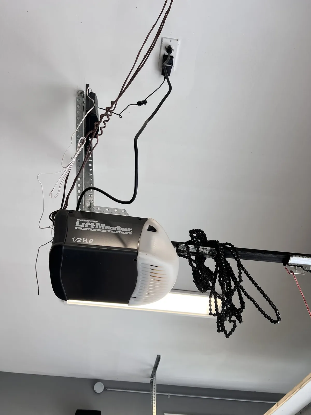 Chamberlain LiftMaster 1/2 HP opener being serviced on a Tsawwassen Shores garage ceiling