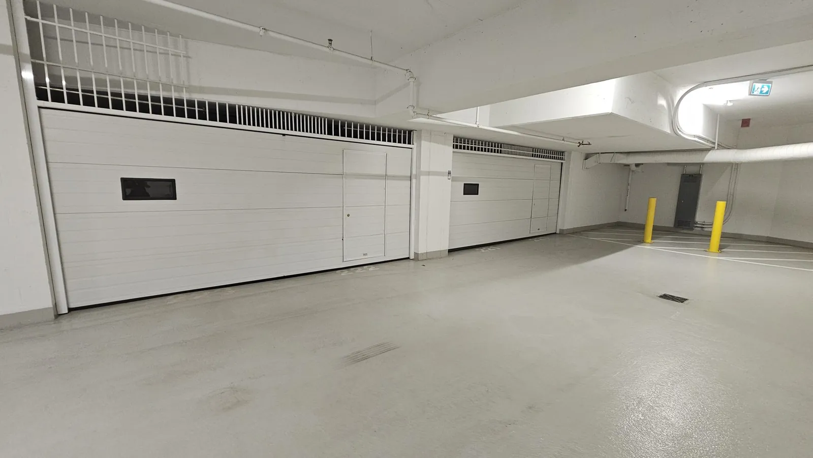 White commercial parkade garage doors in an underground strata garage near Tsawwassen Town Centre