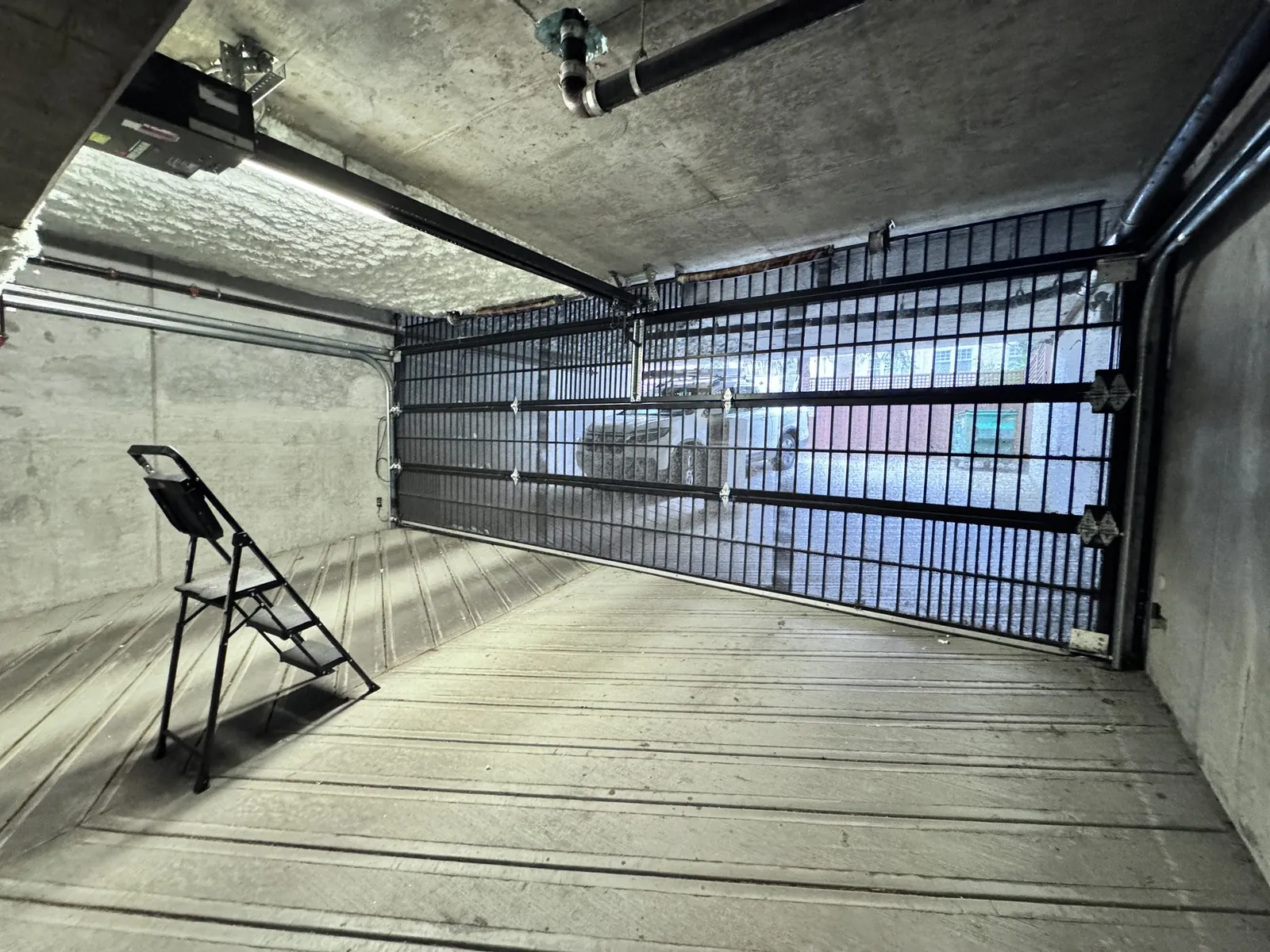 Interior of a commercial parkade with a roll-up sectional gate door at a Tsawwassen strata building