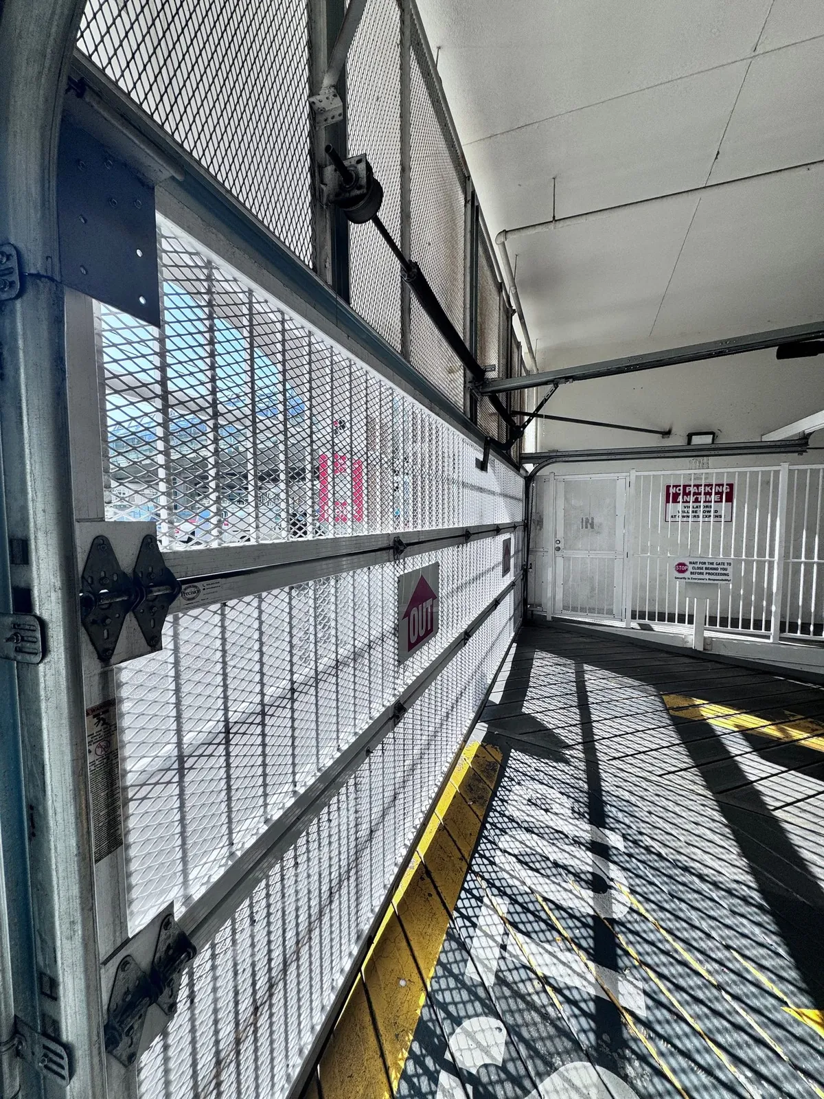 Parkade security gate with IN and OUT lanes at a Tsawwassen strata building