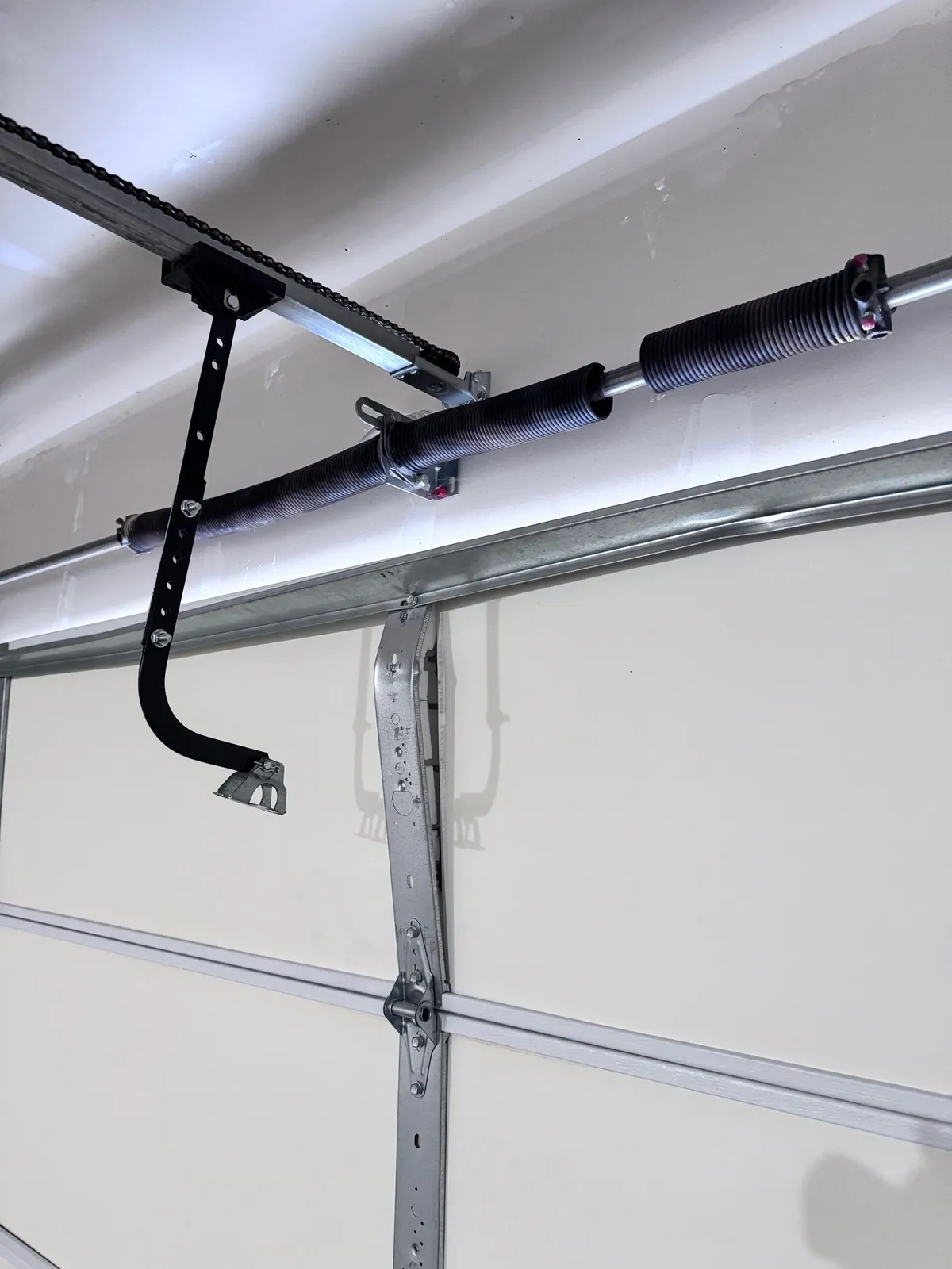 Torsion spring mounted on the shaft above a residential garage door